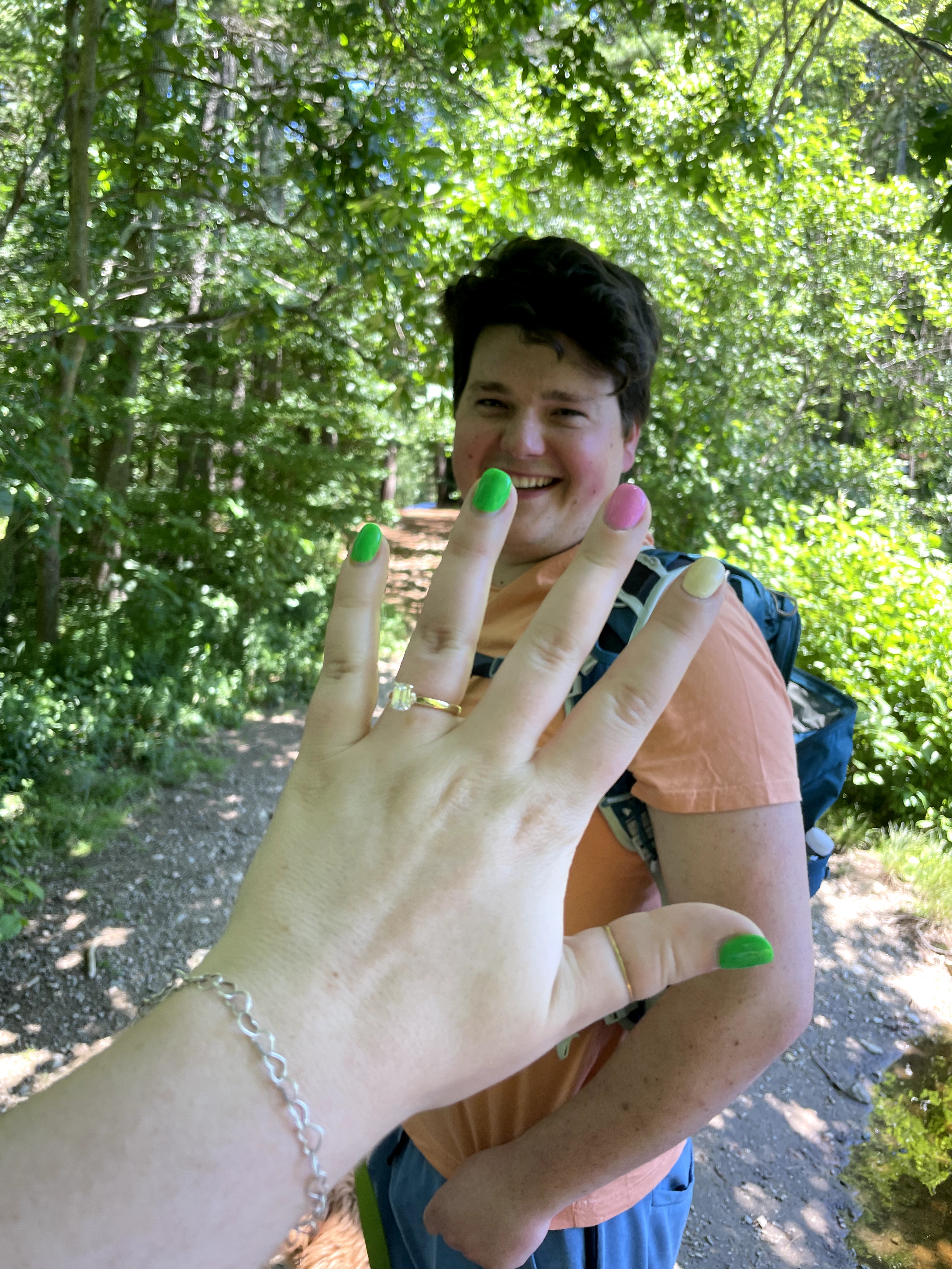 Kayla's hand with her brand new engagemnet ring. Peter in the background.